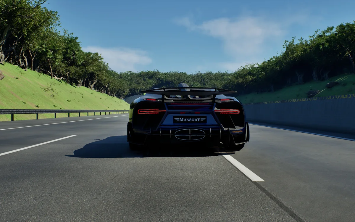 A dark hypercar on the highway through a rainforest cutting